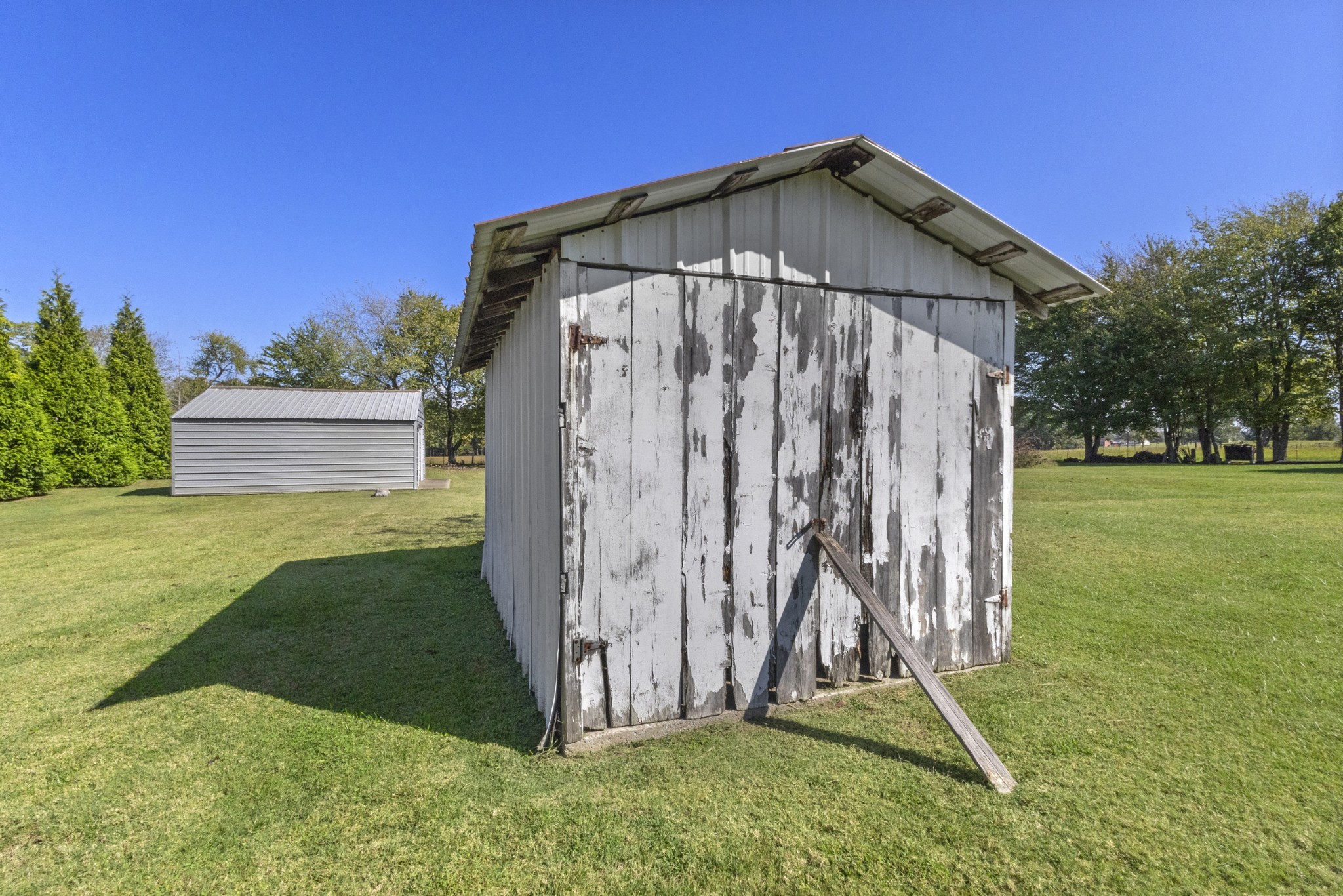 2487 Highway 52 West Portland, TN 37148 - Photo 37 of 49 a blue bench sitting in front of a house with a yard