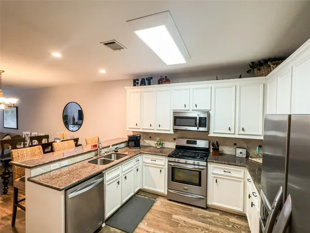 a kitchen with a sink stove and microwave