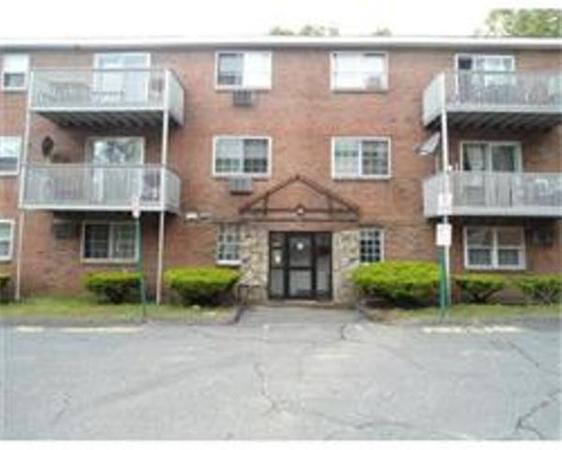 a front view of a brick house with a yard