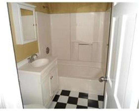 302 Boston Post Road East, Unit B2 Marlborough, MA 01752 - Photo 3 of 6 a bathroom with a sink a toilet a shower and a mirror