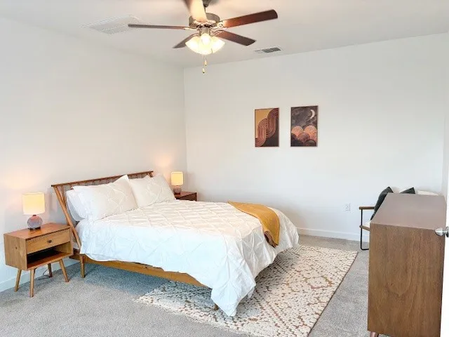 a bedroom with furniture and a large window