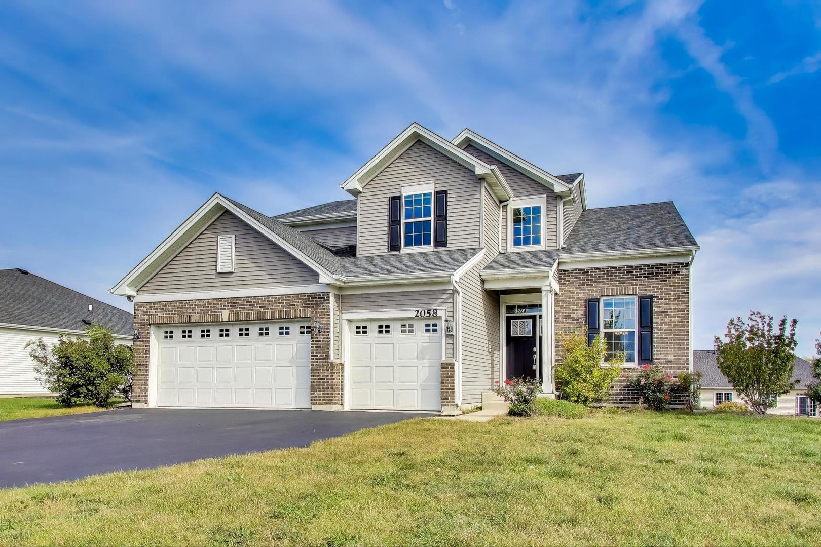 2058 Ingemunson Lane Yorkville, IL 60560 - Photo 1 of 55 a front view of a house with a yard and garage