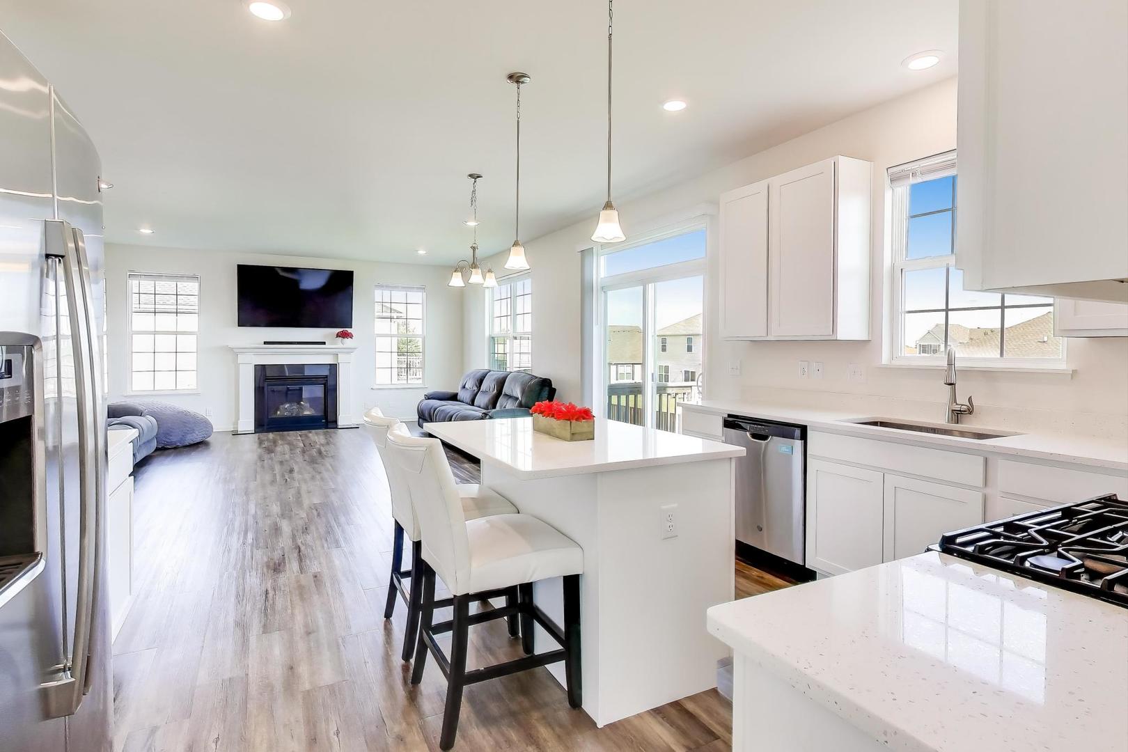 2058 Ingemunson Lane Yorkville, IL 60560 - Photo 2 of 55 a kitchen with stainless steel appliances a stove a sink a kitchen island a stove a table and chairs