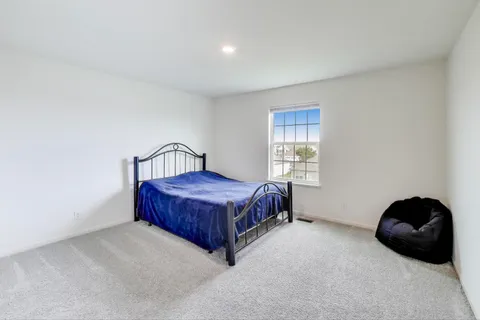 a bedroom with a bed and window