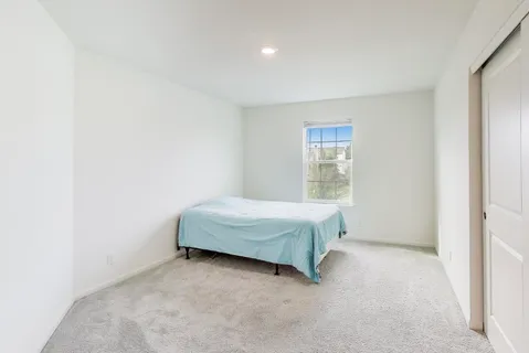 a bedroom with a bed and window