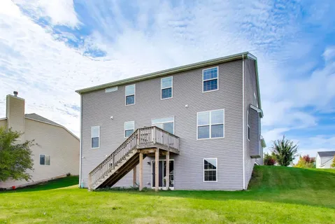 a front view of a house with a big yard