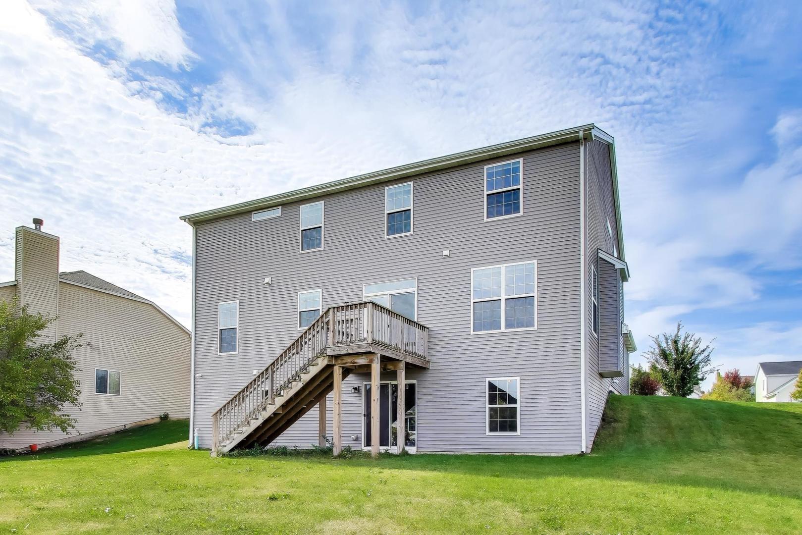 2058 Ingemunson Lane Yorkville, IL 60560 - Photo 38 of 55 a backyard of a house with plants and wooden fence