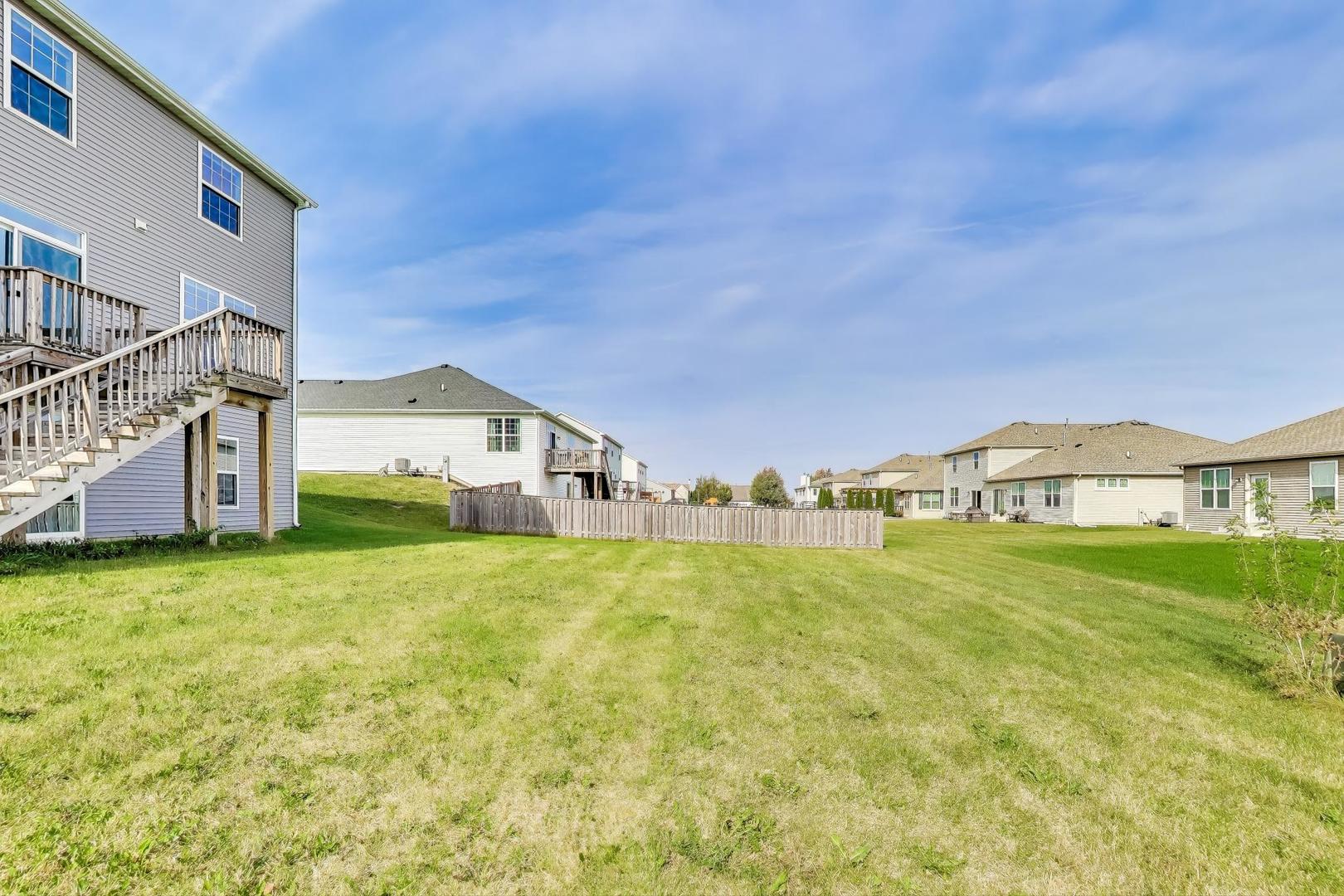 2058 Ingemunson Lane Yorkville, IL 60560 - Photo 40 of 55 a view of a big house with a big yard and large trees