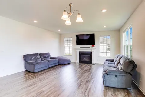 a living room with furniture flat screen tv and a fireplace