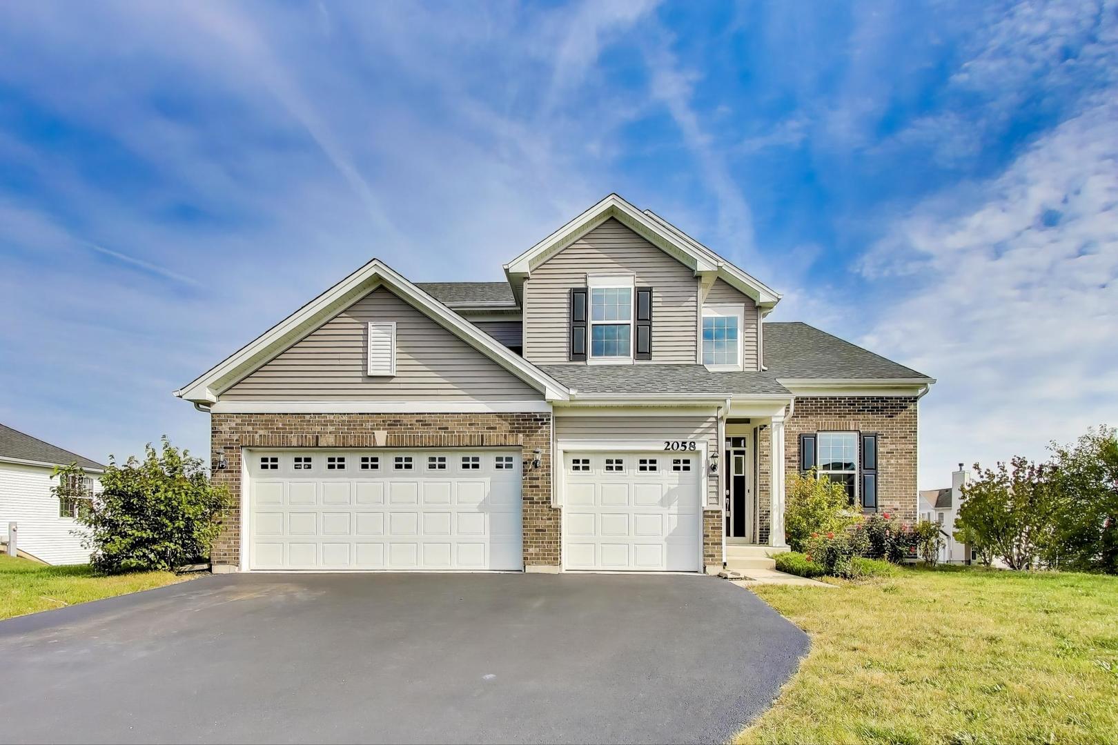 2058 Ingemunson Lane Yorkville, IL 60560 - Photo 52 of 55 a front view of a house with a yard and garage
