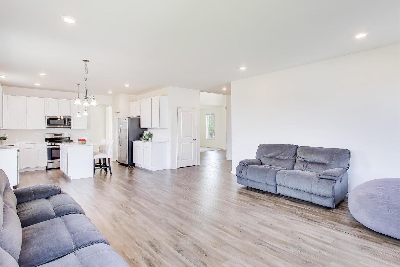 2058 Ingemunson Lane Yorkville, IL 60560 - Photo 6 of 55 a living room with furniture and kitchen view