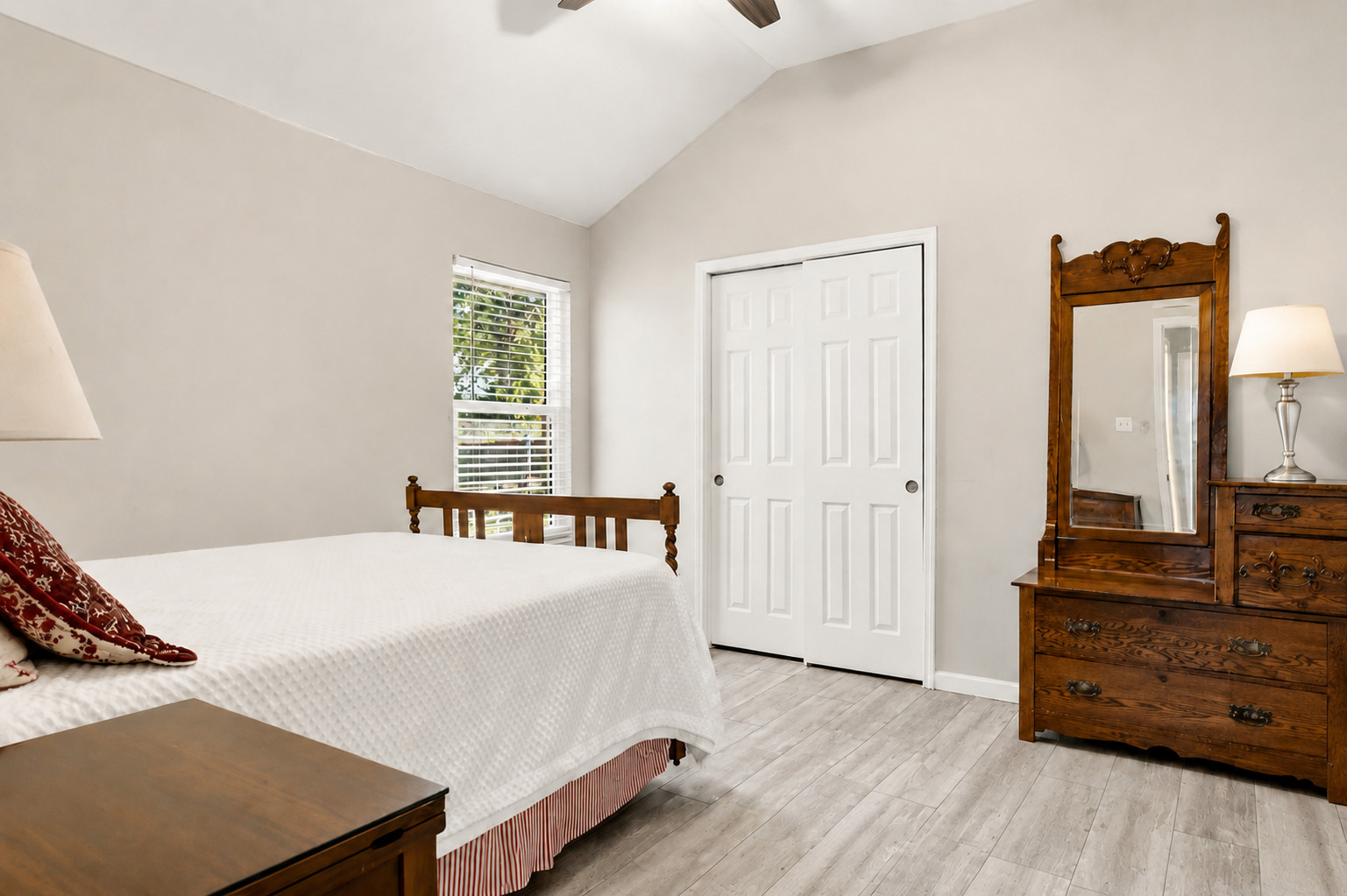1921 Rutherford Drive Leander, TX 78641 - Photo 13 of 29 Vaulted ceilings and wood-style flooring elevate this comfortable bedroom space. Virtually Staged.