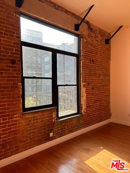 652 Mateo Street, Unit 303 Los Angeles, CA 90021 - Photo 5 of 12 a view of a door and a window