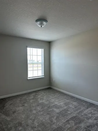 an empty room with a empty space and window