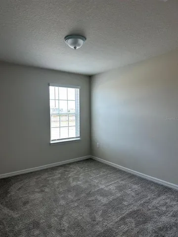 an empty room with a empty space and window