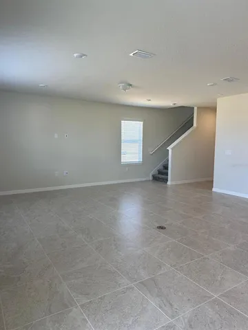 an empty room with windows and pillars in it