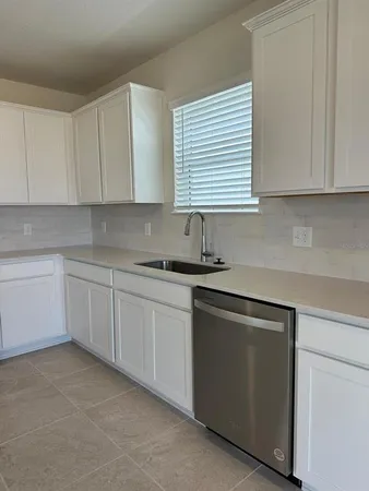 a kitchen with stainless steel appliances a refrigerator sink and microwave