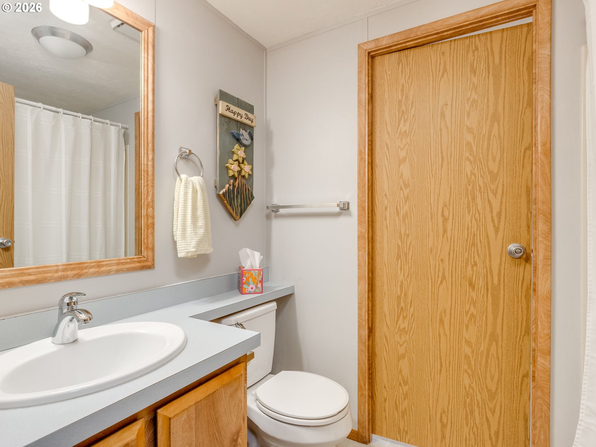 4730 Auburn Road Northeast, Unit 125 Salem, OR 97301 - Photo 14 of 36 a bathroom with a sink a toilet and shower curtain