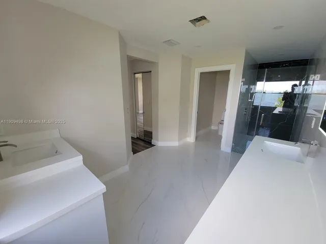 a hallway with a washer and dryer