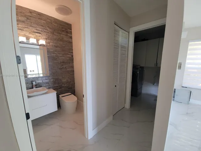 a bathroom with a sink a toilet and tub