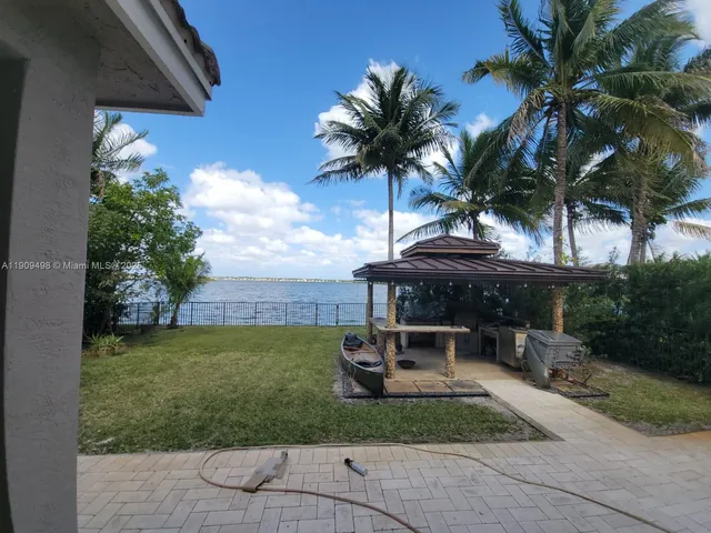 a view of a backyard with sitting area