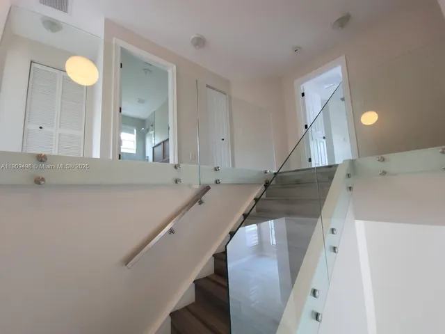 a view of a kitchen with sink and wooden floor