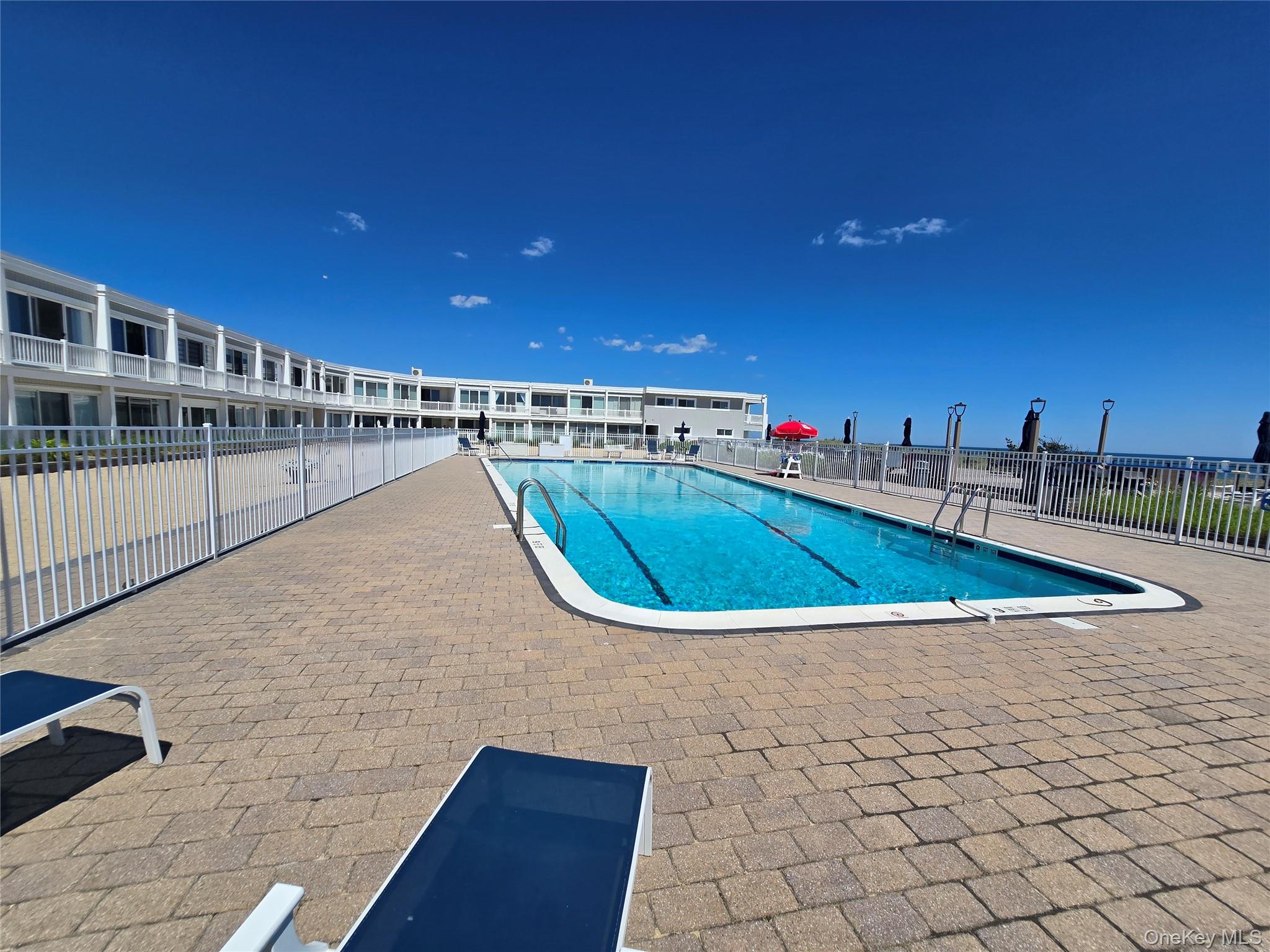 585 Dune Road, Unit L10 Westhampton, NY 11978 - Photo 3 of 25 Outdoor swimming pool with integrated lane lines
