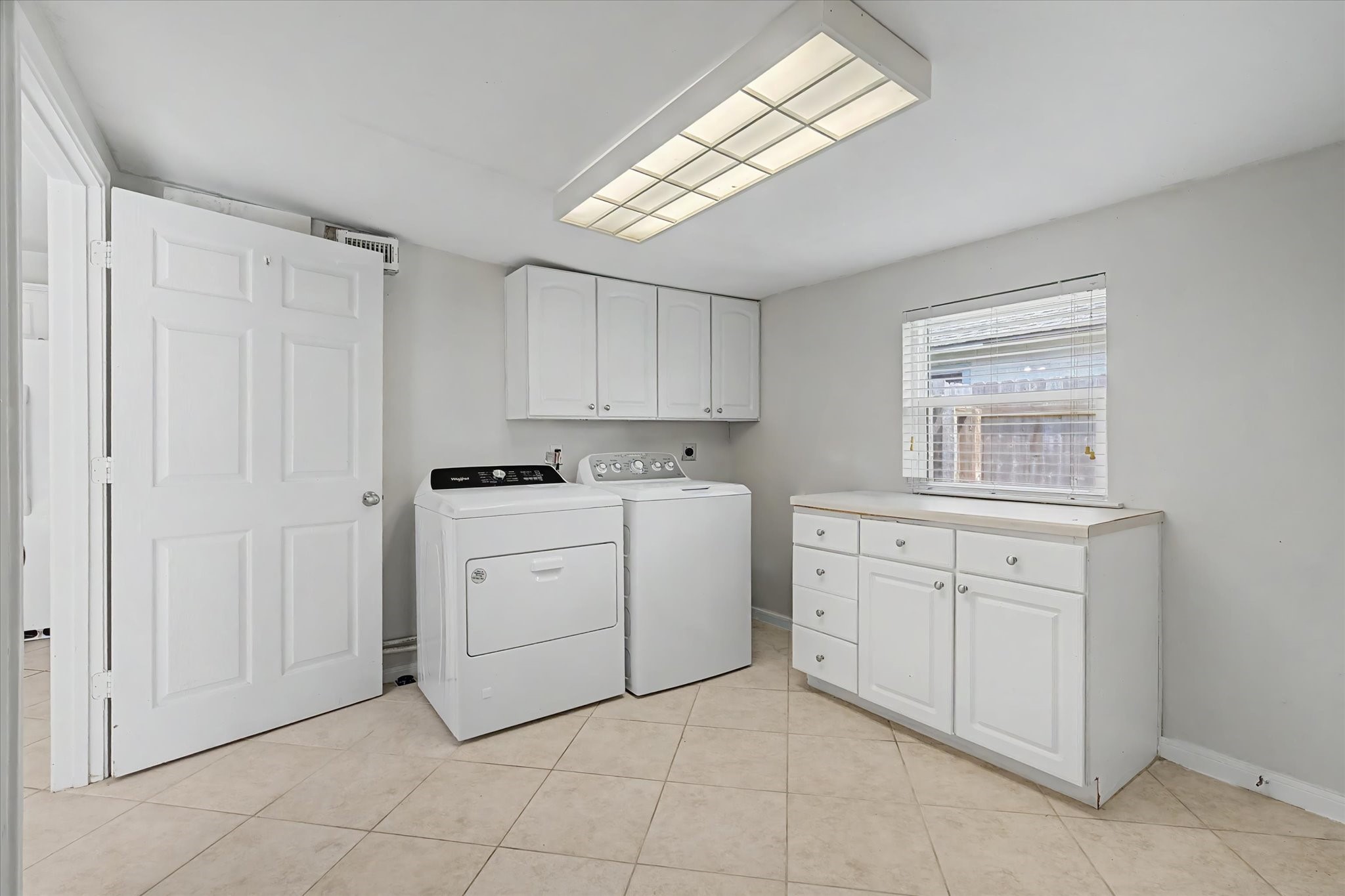 413 Farrer Street Angleton, TX 77515 - Photo 19 of 43 a kitchen with cabinets appliances a sink and a window