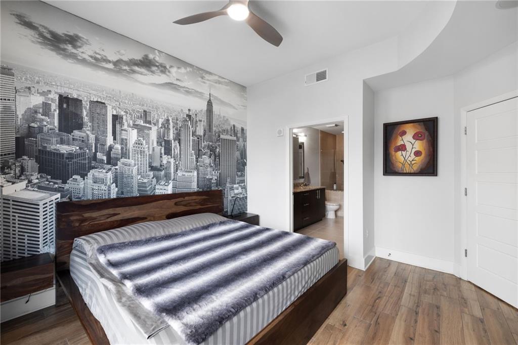 1080 Peachtree Street Northeast, Unit 1812 Atlanta, GA 30309 - Photo 4 of 13 a bedroom with a bed and a view of bathroom