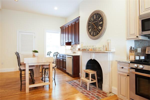 a view of a kitchen with workspace and a fireplace