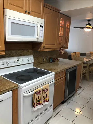 a kitchen with stainless steel appliances a refrigerator and a stove