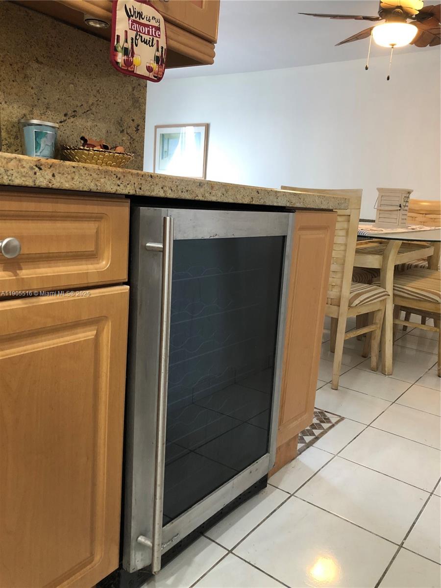 6969 Collins Avenue, Unit 607 Miami Beach, FL 33141 - Photo 7 of 15 a kitchen with stainless steel appliances a refrigerator and a stove