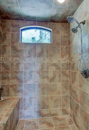 a bathroom with a shower and a sink