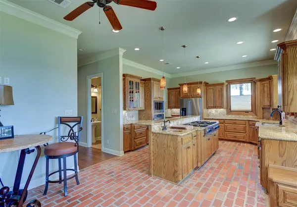 a kitchen with stainless steel appliances granite countertop a stove oven and a refrigerator