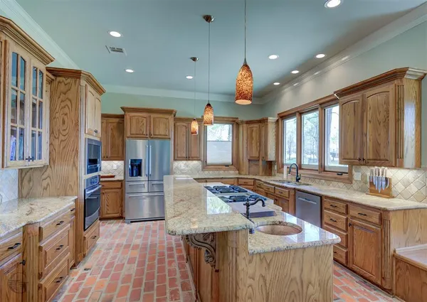 a kitchen with sink stove and refrigerator