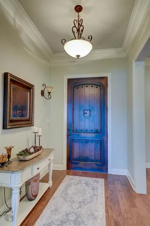a room with a chandelier and dresser