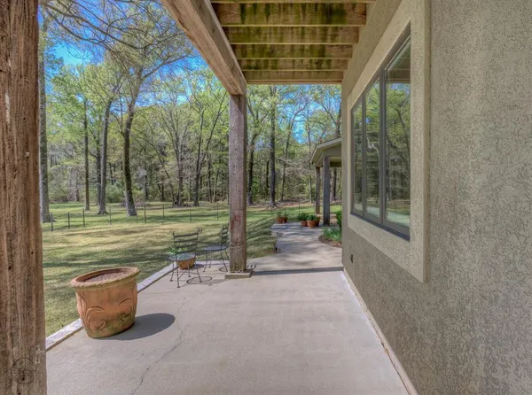 a floor to ceiling window next to a yard
