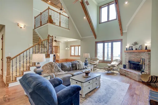 a living room with furniture fireplace and a window