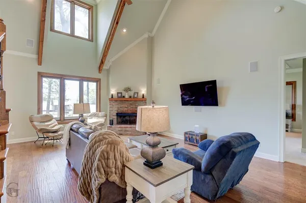 a living room with fireplace furniture and a flat screen tv