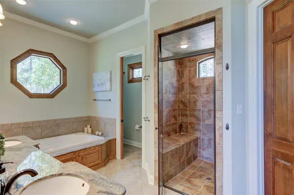 a bathroom with a tub shower and sink