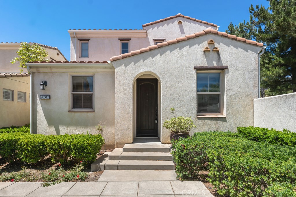 20317 Livorno Porter Ranch Porter Ranch, CA 91326 - Photo 1 of 33 a front view of a house with garden