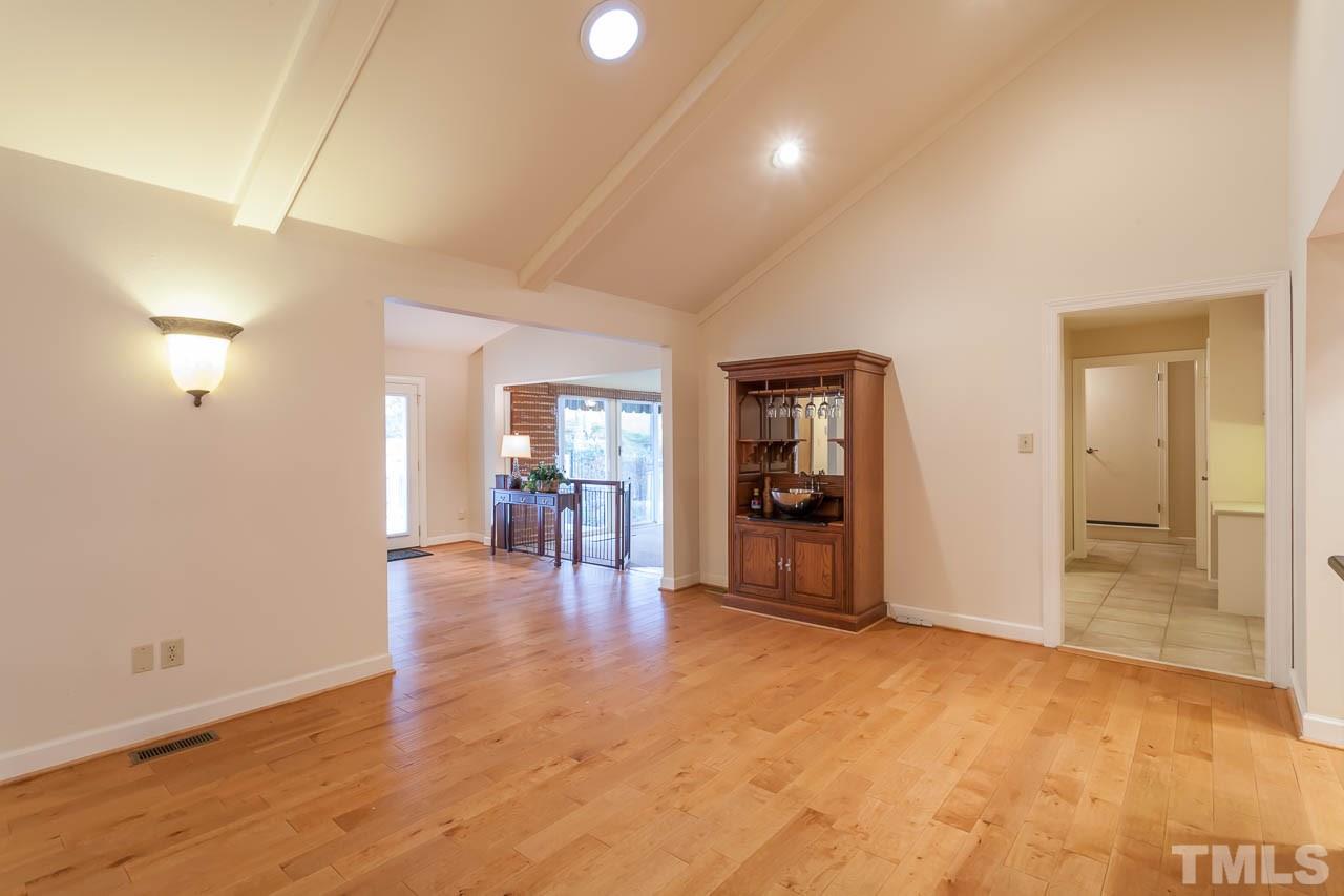 6909 Valley Ridge Court Raleigh, NC 27615 - Photo 11 of 25 wooden floor in an empty room with a window