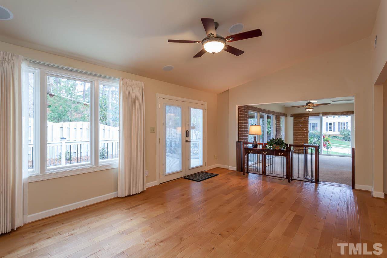 6909 Valley Ridge Court Raleigh, NC 27615 - Photo 13 of 25 a view of an empty room with window and wooden floor