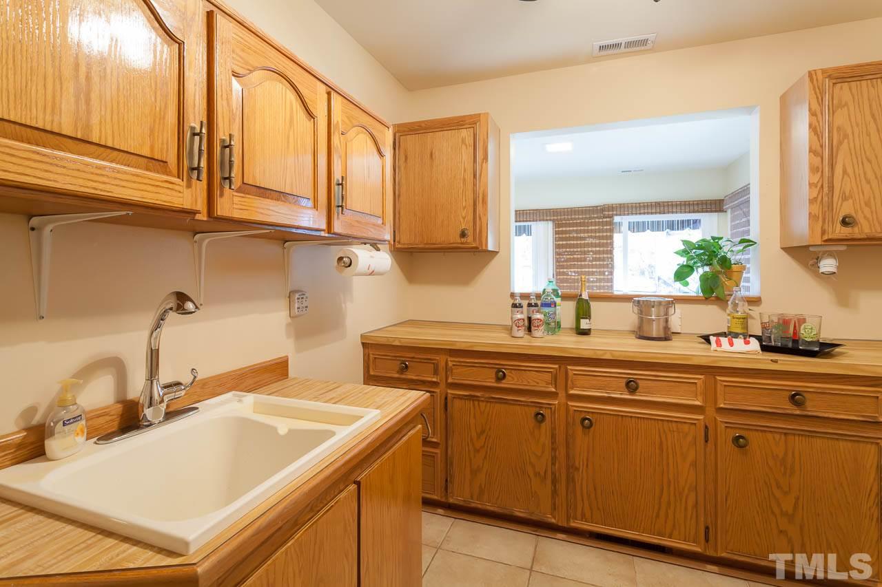 6909 Valley Ridge Court Raleigh, NC 27615 - Photo 15 of 25 a kitchen with a sink cabinets and appliances