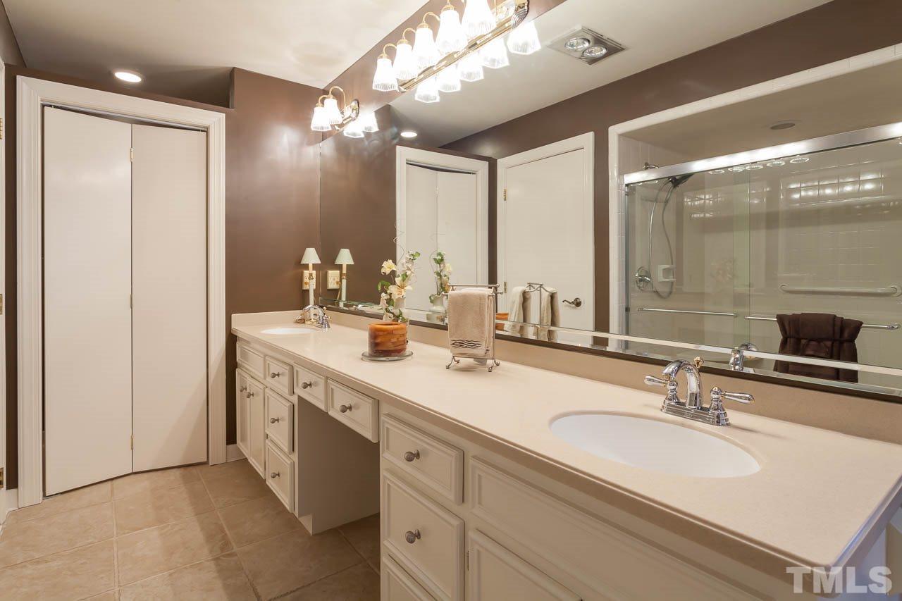 6909 Valley Ridge Court Raleigh, NC 27615 - Photo 18 of 25 a bathroom with a sink double vanity and a mirror