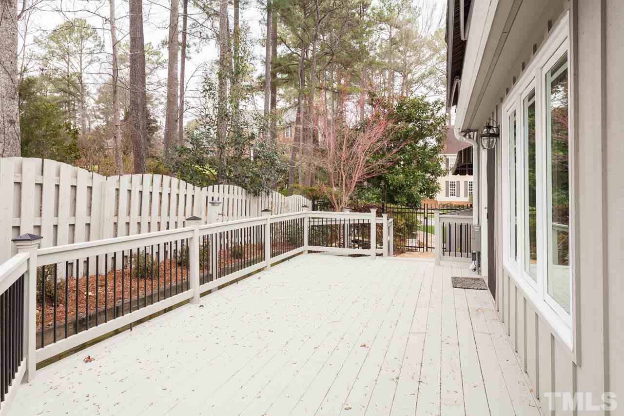 6909 Valley Ridge Court Raleigh, NC 27615 - Photo 24 of 25 a view of a balcony with wooden floor and fence