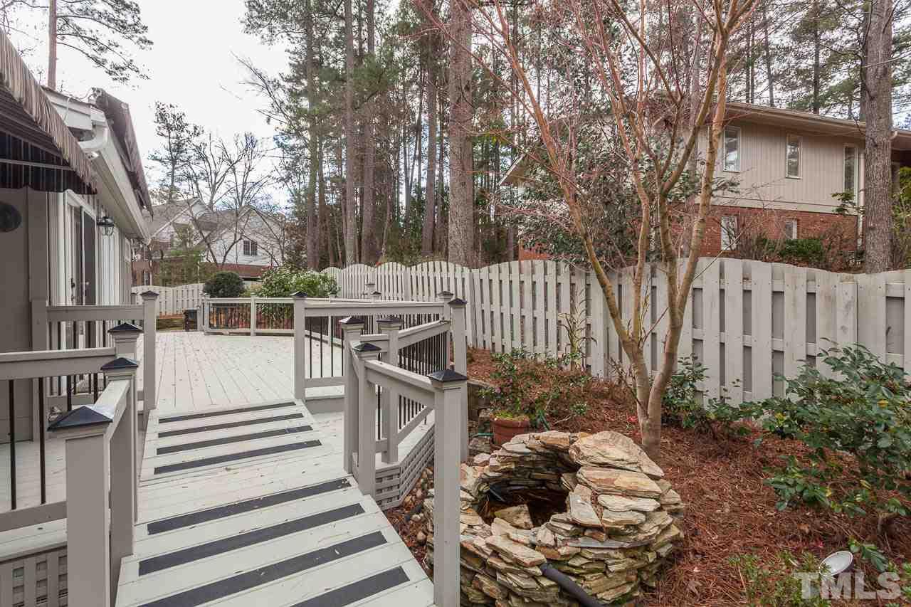 6909 Valley Ridge Court Raleigh, NC 27615 - Photo 25 of 25 a view of a house with a backyard and trees