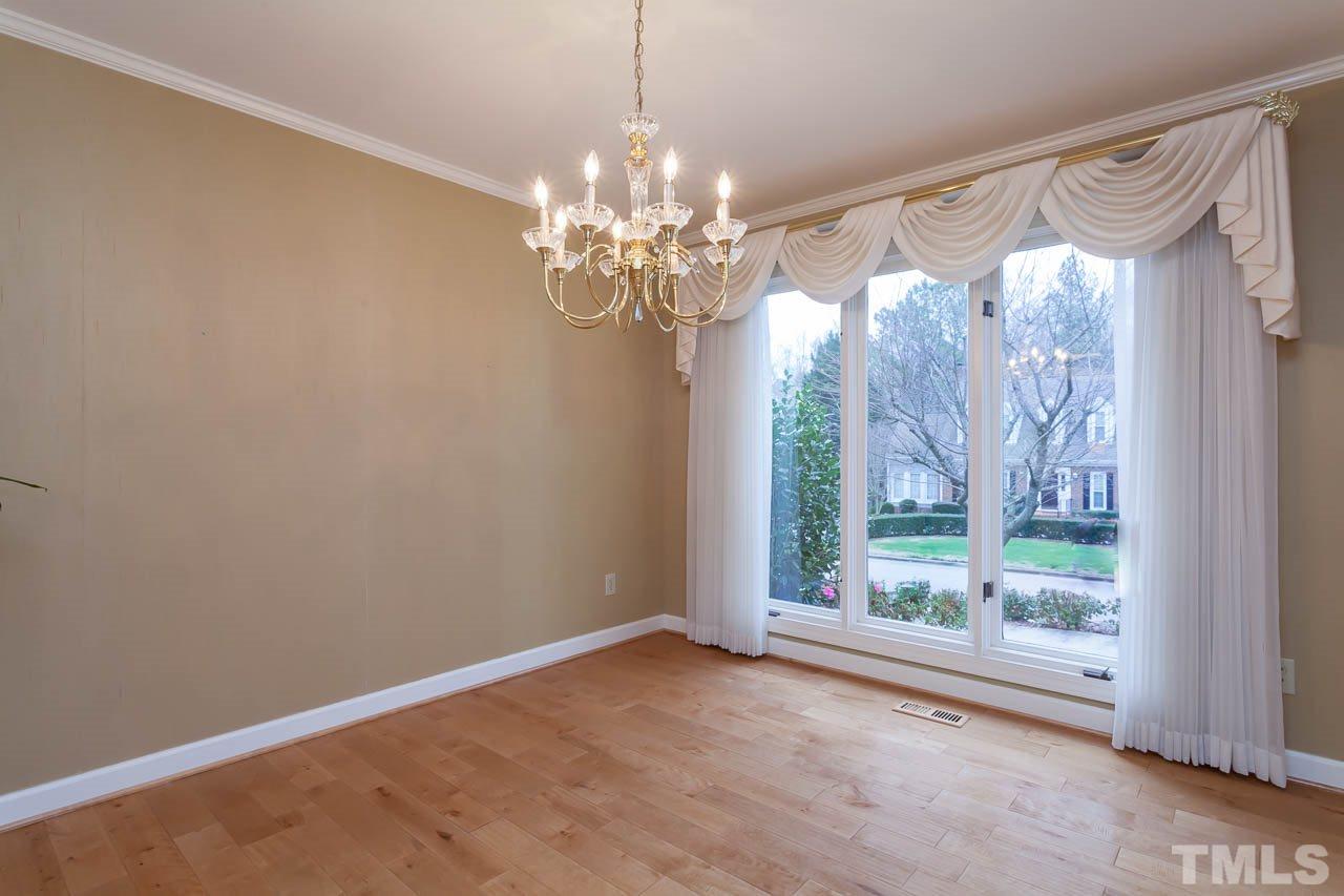 6909 Valley Ridge Court Raleigh, NC 27615 - Photo 7 of 25 a view of a big room with window chandelier and mountain view