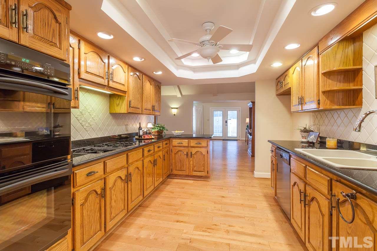 6909 Valley Ridge Court Raleigh, NC 27615 - Photo 8 of 25 a large kitchen with stainless steel appliances granite countertop a large stove a sink and dishwasher a oven with large countertops