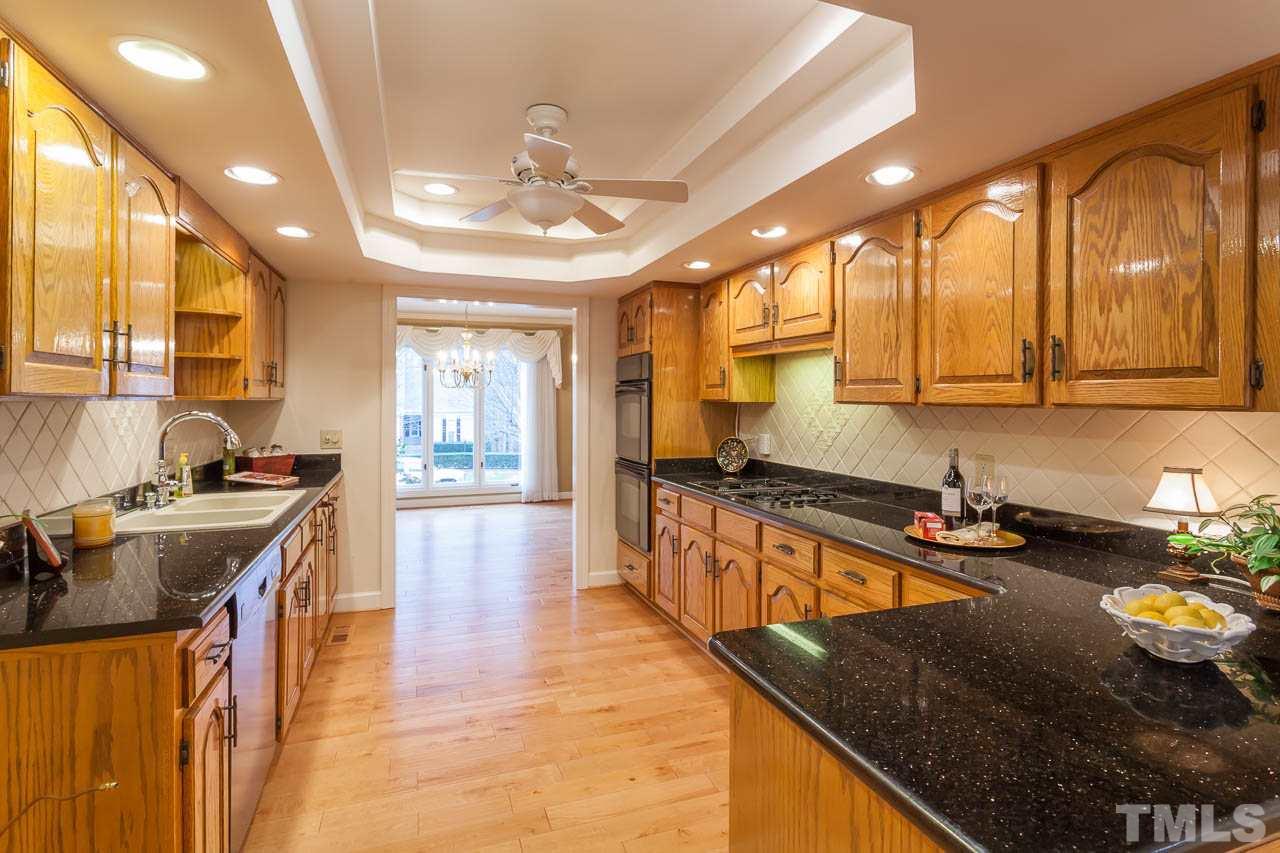 6909 Valley Ridge Court Raleigh, NC 27615 - Photo 9 of 25 a kitchen with stainless steel appliances granite countertop a sink stove and cabinets